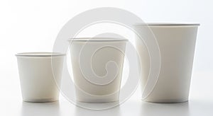 Three disposable paper cups of varying sizes showing gradual increase in volume and capacity