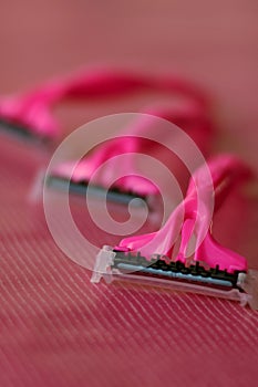 Three disposable pink shaving razors
