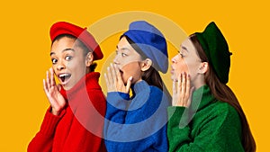 Three Diverse Women Whispering Sharing Rumors Standing Over Yellow Background