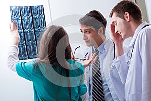 The three doctors discussing scan results of x-ray image