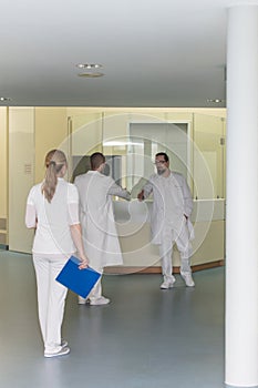 three doctors in a hospital corridor