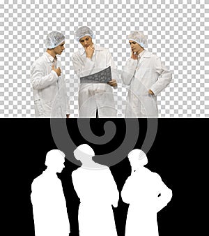 Three doctors rhythmically look at an x-ray photo of a patient t