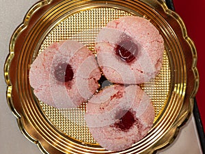 Three Donuts Covered with Pink Sugary Icing and Filled with Strawberry Jam