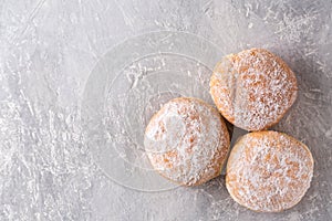 Three donuts on a gray background, top view