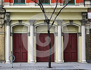 Three doors in a row with corinthian columns