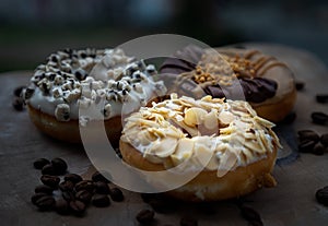 Three doughnuts covered with Almendras, Cookies and creme and Choco peanut butter photo