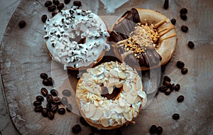 Three doughnuts covered with Cookies and creme, Almendras and Choco peanut butter