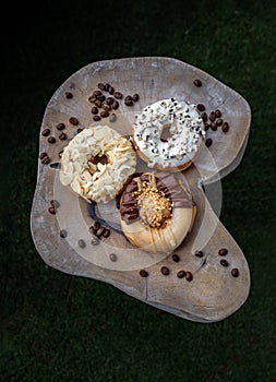 Three doughnuts covered with Cookies and creme, Almendras and Choco peanut butter photo