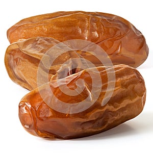 Three dried dates in close up on white background. Front view . Full depth of field