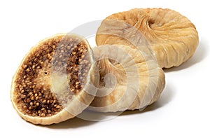 Three dried figs in close up on white background. Front view . Full depth of field