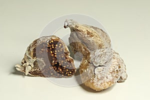 Three dried figs isolated on a white, a vegetarian candy