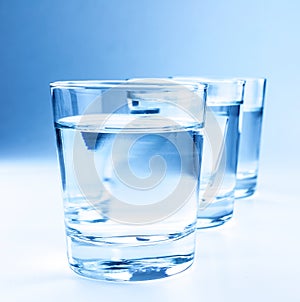 Three drink glasses with water, nutrition and health-care concept