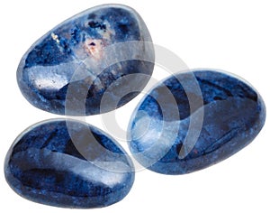 Three Dumortierite gemstones isolated on white photo