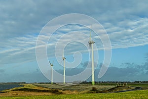 Three Dutch windmills in a row for creating windenergy