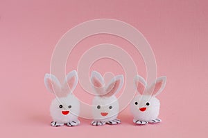 Three Easter Bunnies on a Pink Background.