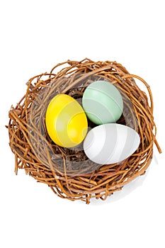 Three Easter egggs in a bird nest isolated