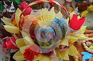 Three Easter eggs are decorated with beads.