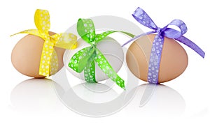 Three Easter eggs with festive bow isolated on white background