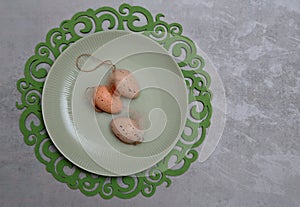 Three Easter eggs on a greenish plate