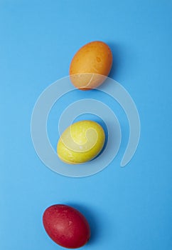 Three easter eggs on blue background