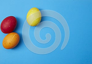 Three easter eggs on blue background