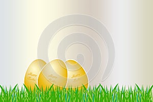 Three Easter golden eggs lying on the grass