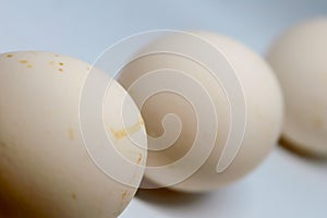 Three eggs over a white background.