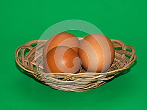 Three eggs in the palte over green, isolated