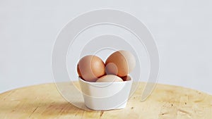 Three eggs in white bowl