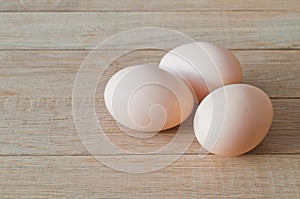 Three eggs on a wooden table