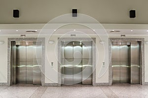 Three elevator doors in corridor