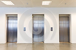 Three elevators in office building photo