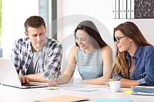 Three employees coworking at office photo