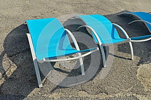 Three empty beach chairs