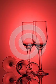 Three empty champagne glasses on colored background