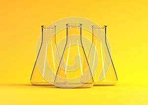 Three empty erlenmeyer flask on yellow background