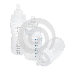 Three empty feeding bottles for infant formula on white background