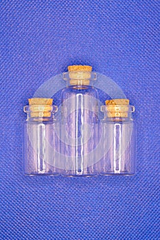 Three empty glass bottles with stoppers for storing