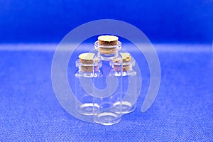 Three empty glass bottles with stoppers storing