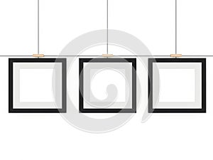 Three empty picture frames hanging on wall, isolated on white background