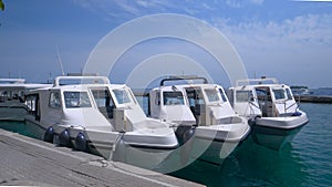 Three empty water taxis waiting for tourists in the tranquil docks.
