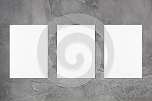 Three empty white vertical rectangle poster mockups