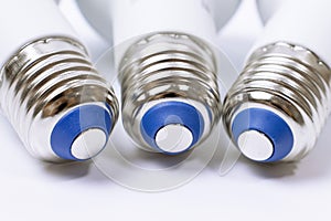 Three energy saving lamp e27 sockets on white background close up