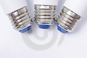 Three energy saving lamp e27 sockets on white background close up