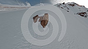 Three extreme sport people climbing on high snowy mountain summit riding snowboard