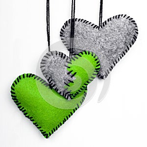 Three felt heart on a white background,