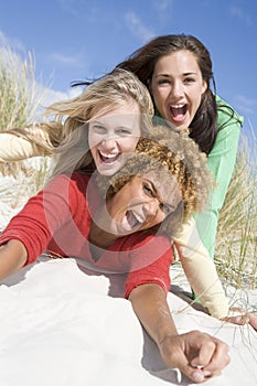 Three female friends having fun at beach