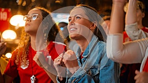 Three Female Friends Watching a Live Soccer Match on TV in a Sports Bar. Happy Girls Cheering and