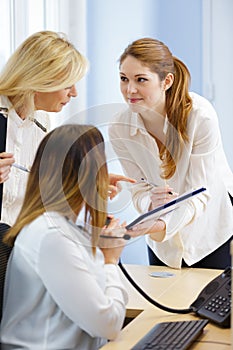 three female workers being in office