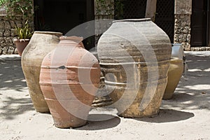 Three fictile old jugs on the sand photo